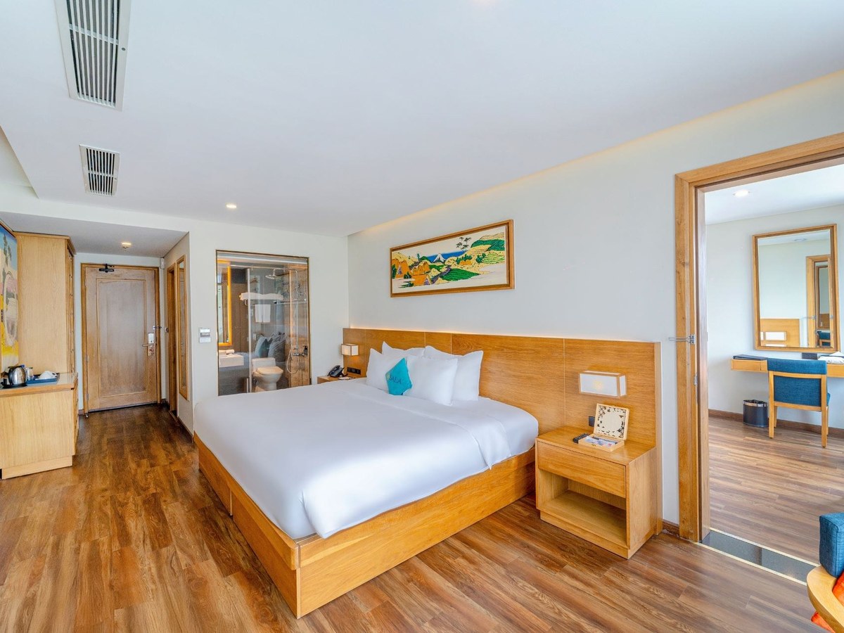 Bedroom in a family suite with a double bed and an open connecting door to a second room